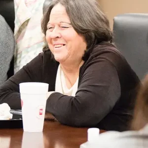 Woman smiling at support group