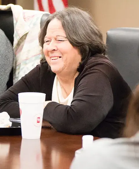 Woman smiling at support group