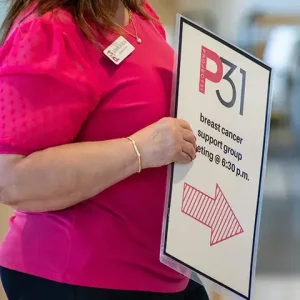 Woman holding sign for support group