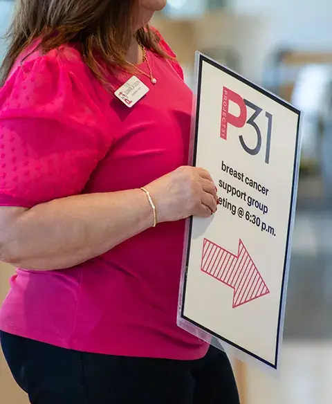 Woman holding sign for support group
