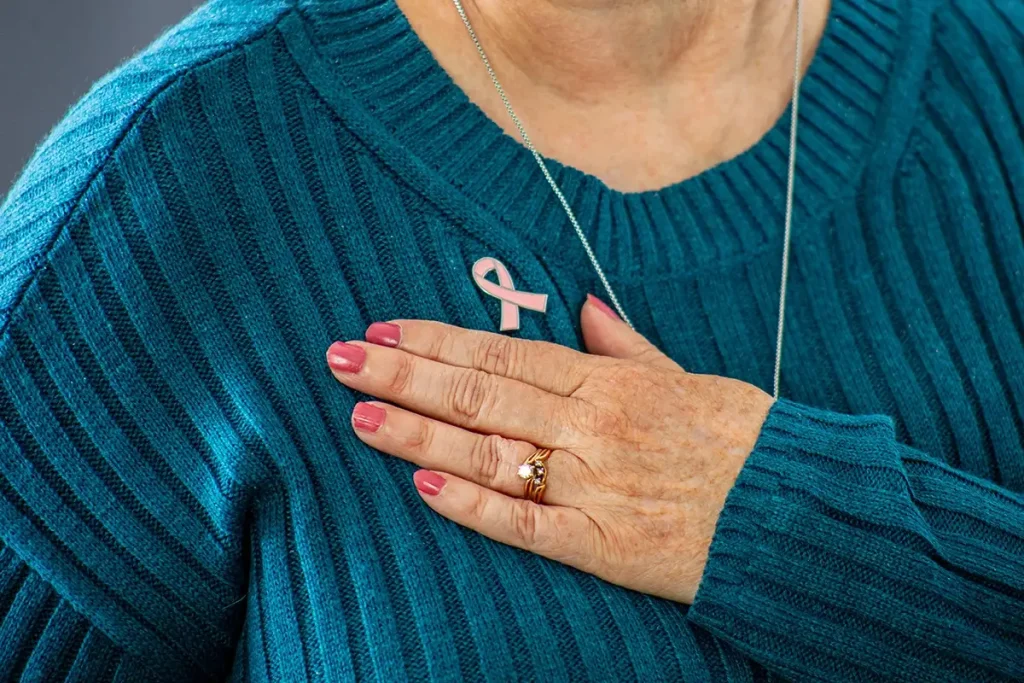 Woman wearing pink ribbon pin