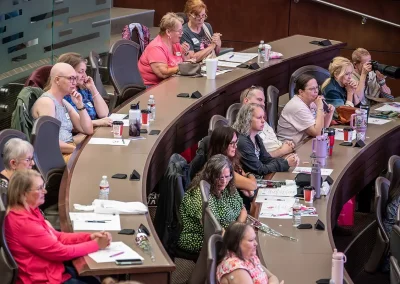 Attendees sitting in lecture hall desks at the OKC Expo