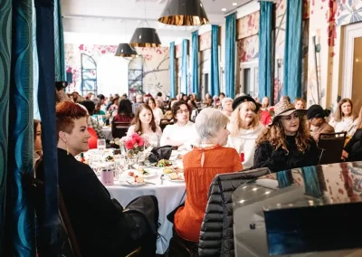 A crowd of women sitting at tables