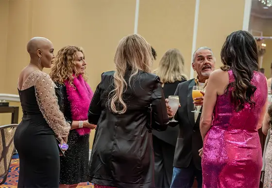 Group talking at Paint the Town Pink Gala
