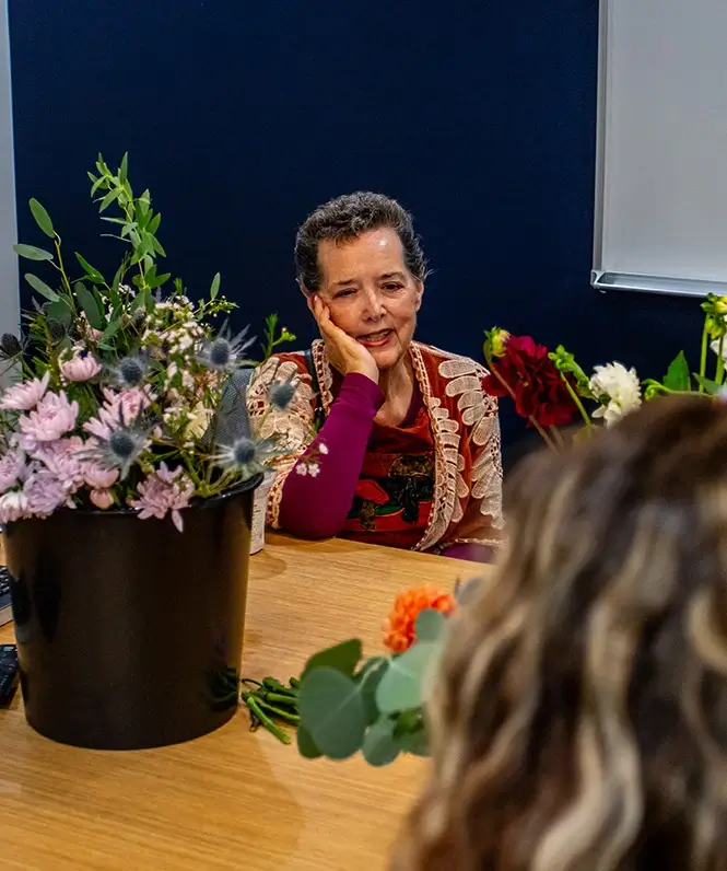 Woman smiling during support group bouquet making event