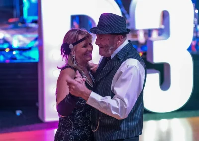 An older couple dressed in costume dance together