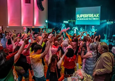 A crowd dances to YMCA