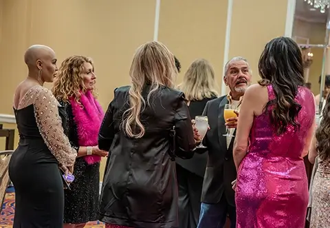 People talking at Paint the Town Pink gala