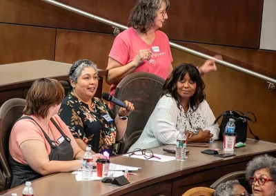 A breast cancer survivor asks a question in a microphone at the Expo
