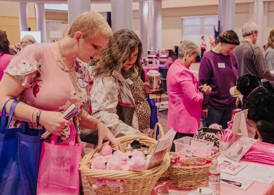 Expo attendees stop and read papers at vendor booths