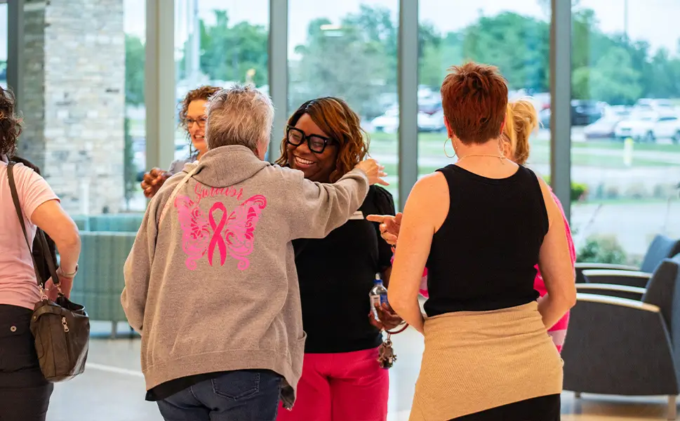 Women hugging outside of support group