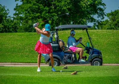 A golfer swings her club
