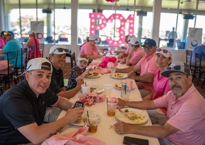 A table of golfers eat lunch