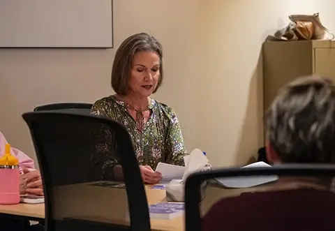 Woman leading group discussion about book