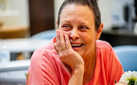 Laughing woman wearing pink shirt