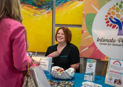 Tracy with Intimate Pathways smiles while talking to Expo attendee