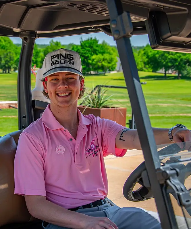 Man driving golf cart at Sink4Pink