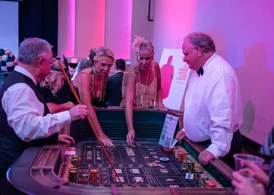 Three woman and a man play casino games