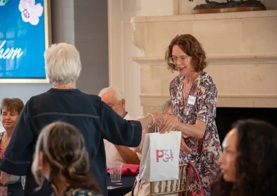 A woman receives a raffle prize bag