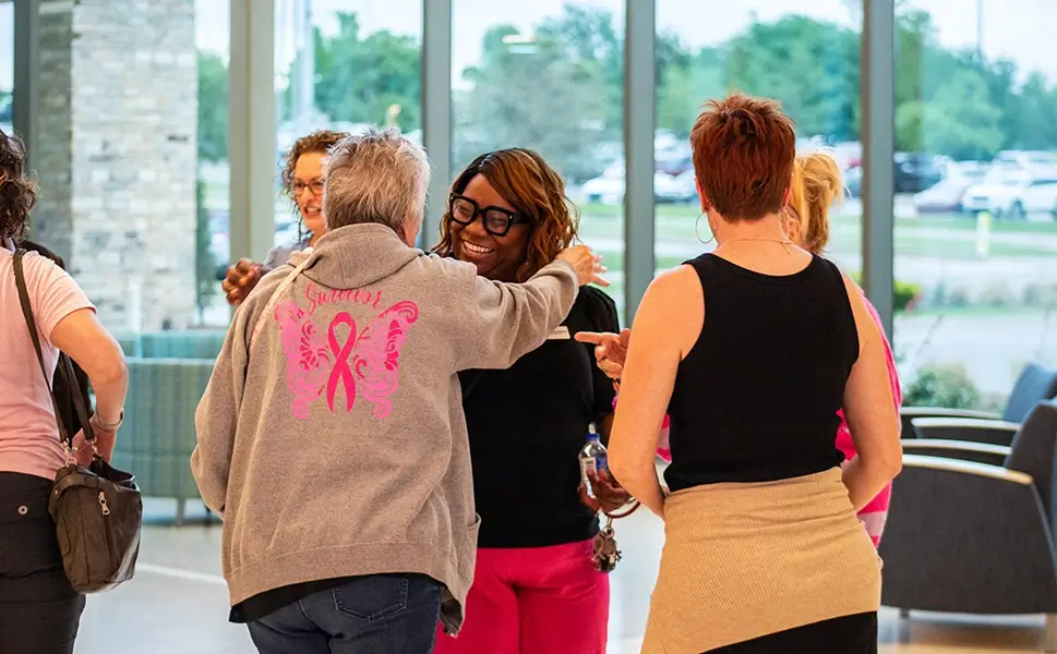 Women smiling outside of support group meeting.