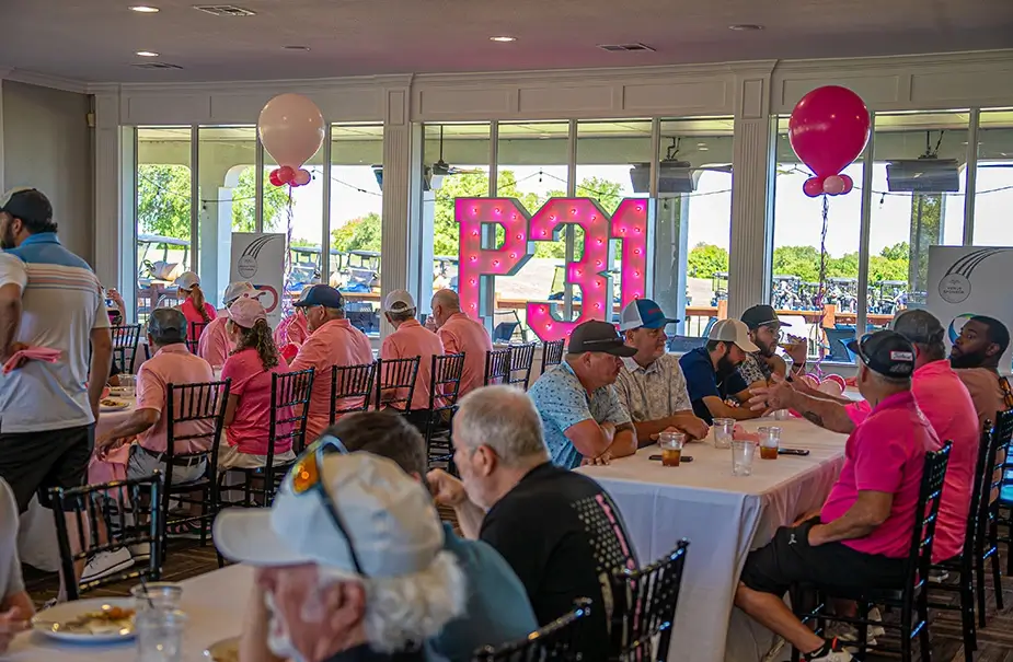 A room full of golfers eating lunch at the Sink4Pink Golf Tournament