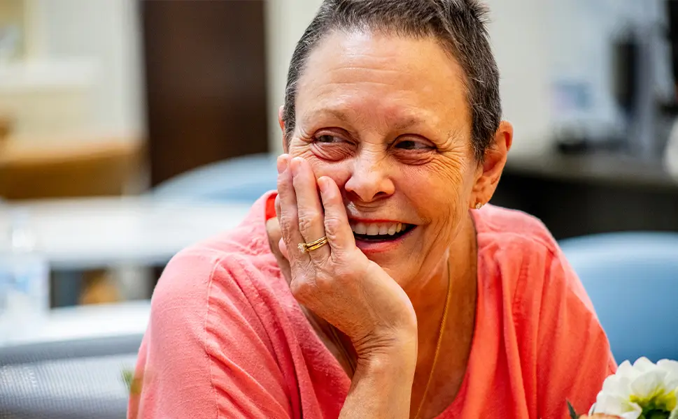 Woman smiling during support group event