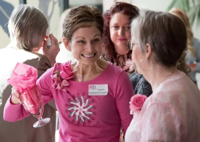 A survivor smiles with a gifted glass