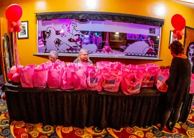 Pink bags line a gift table