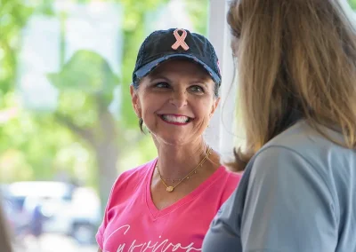 A survivor smiles while talking with another woman