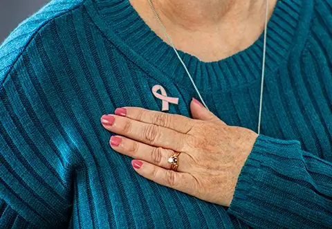 Woman wearing Breast Cancer Awareness ribbon pin