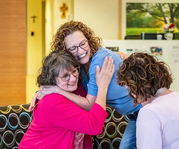 Two Project31 staff members hug