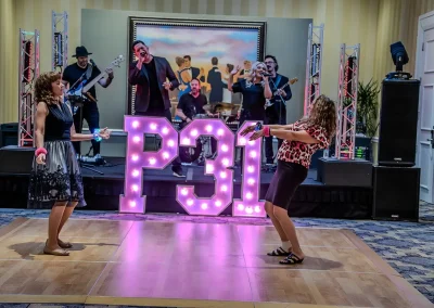 Two women dance on dance floor