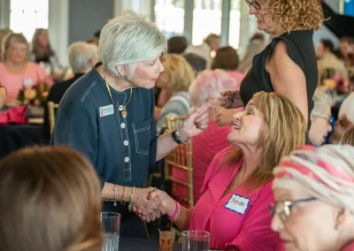 Two women meet and shake hands