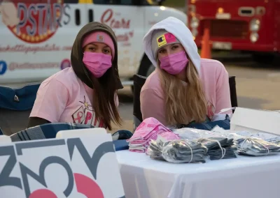 Two women wearing masks at vendor booth